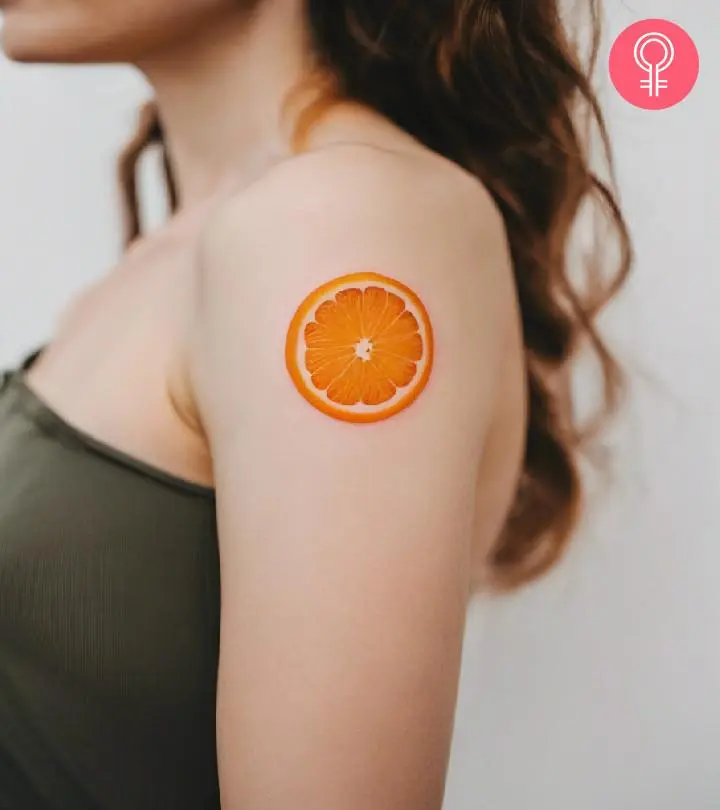 A woman with a vibrant orange tattoo on her upper arm