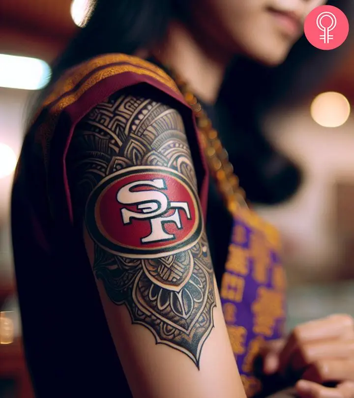 A woman with an elaborate SF 49ers tattoo on her upper arm