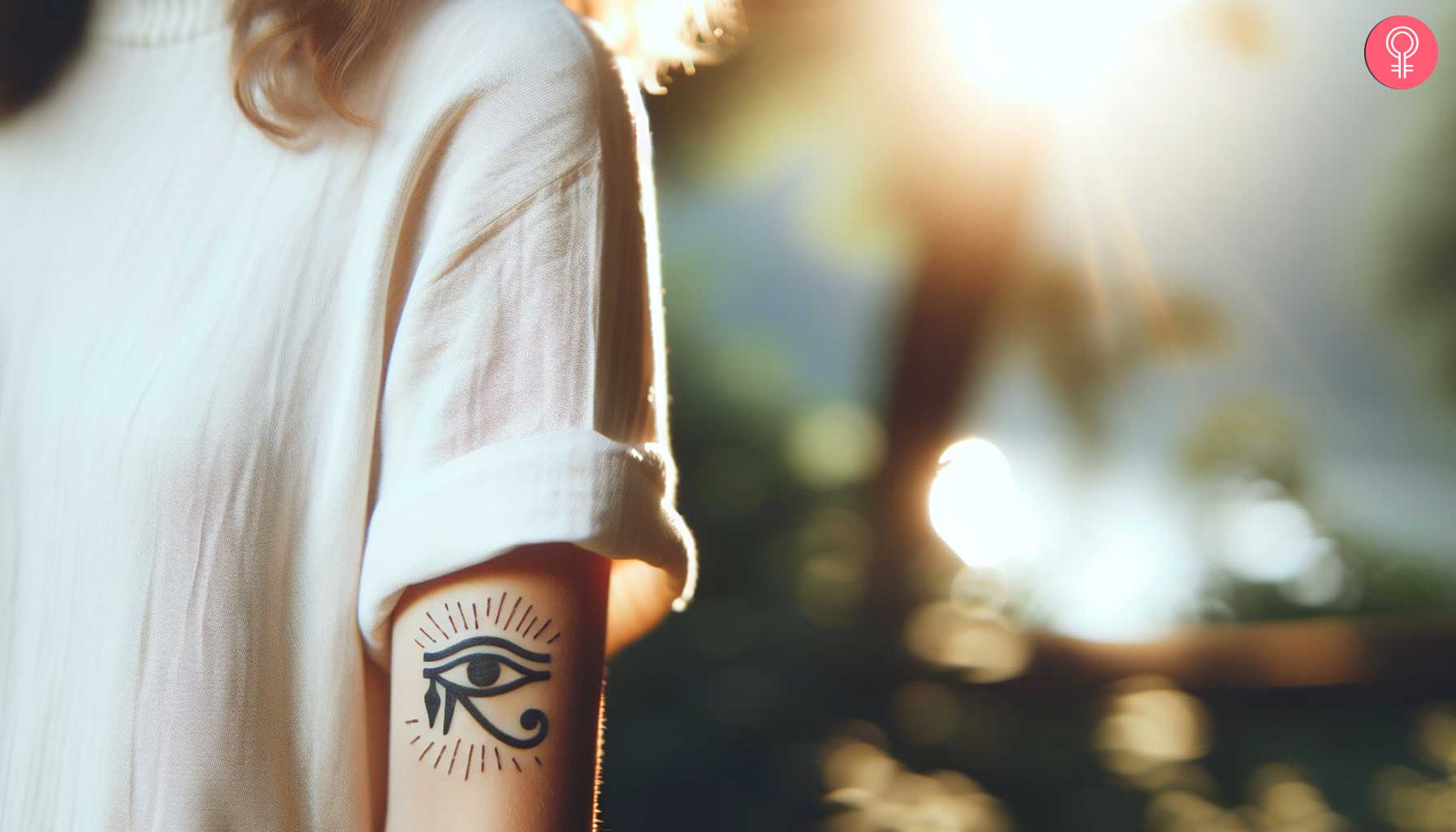 A woman with an eye of Thoth tattoo on her upper arm