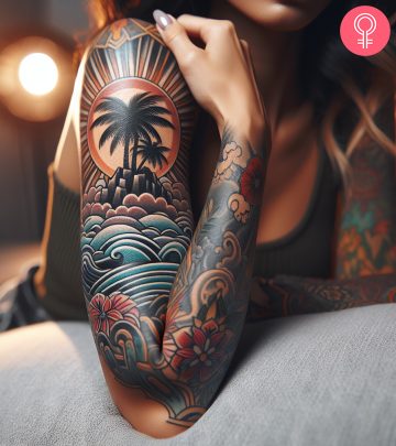 Woman with a tropical island tattoo on the upper arm