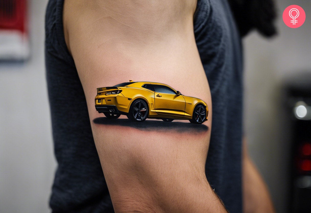 A yellow, sleek chevy Camaro tattoo on the bicep