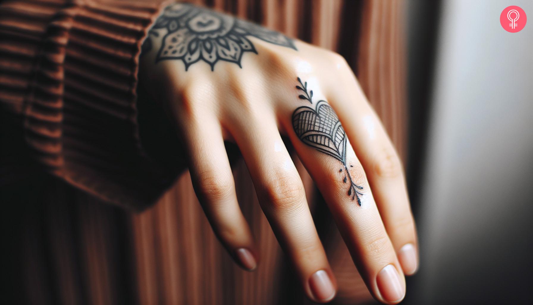 A faded heart tattoo on the finger