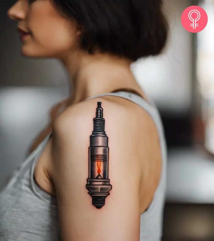 A woman with a spark plug tattoo on her upper arm