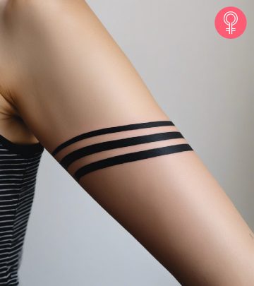 A tribal armband tattoo on the forearm