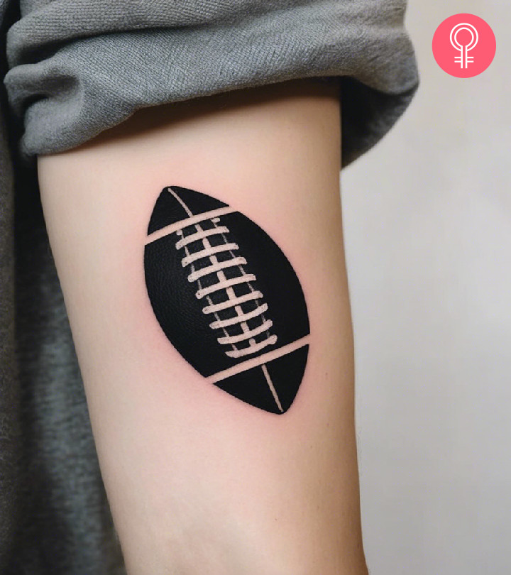 American football ball tattoo on the arm