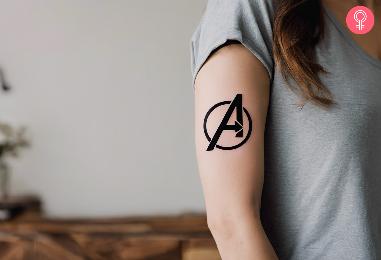 Avengers logo tattoo on a woman’s upper arm