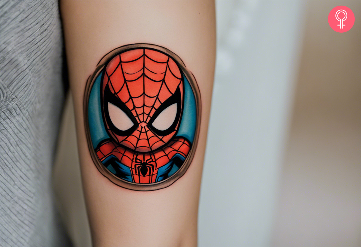 Tattoo of baby spider man on the upper arm