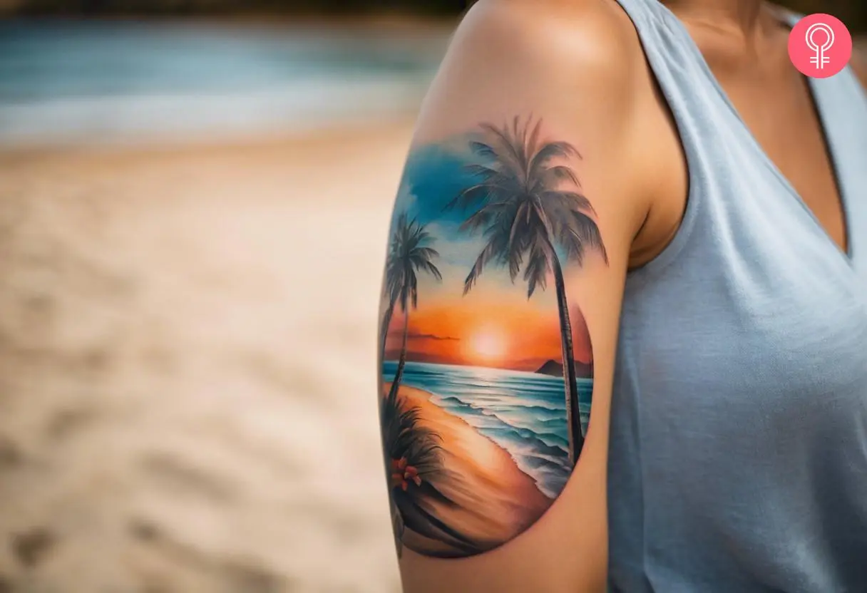 A woman with a colorful beach scenery tattoo on her upper arm