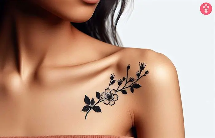 Hawthorn tattoo on a woman’s shoulder rendered in black and white