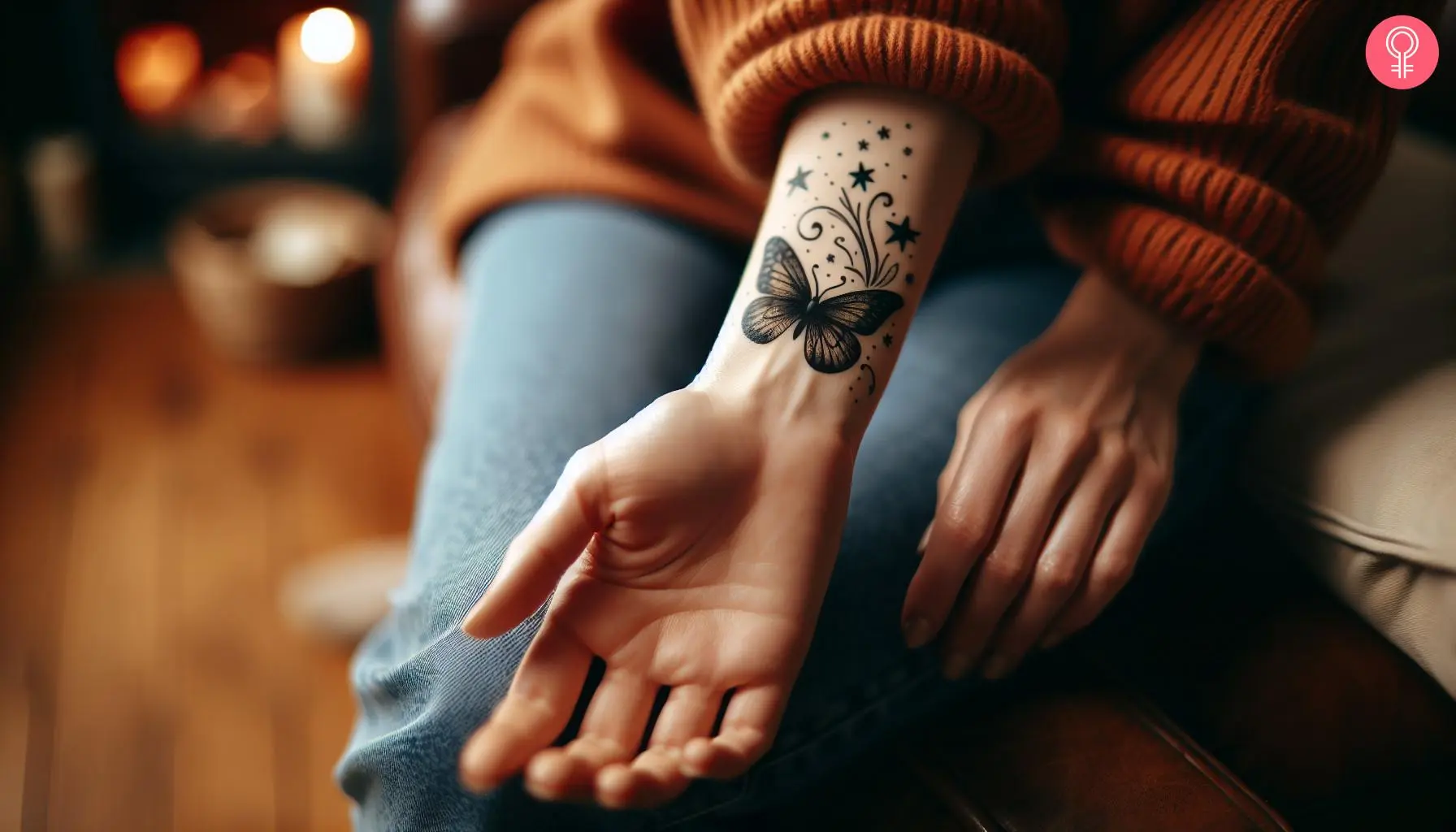 A woman with a black butterfly and stars tattooed on her wrist