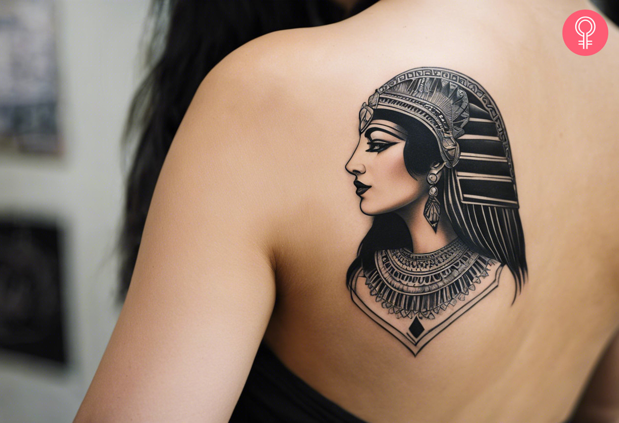 A woman with a black Cleopatra tattoo on her upper back