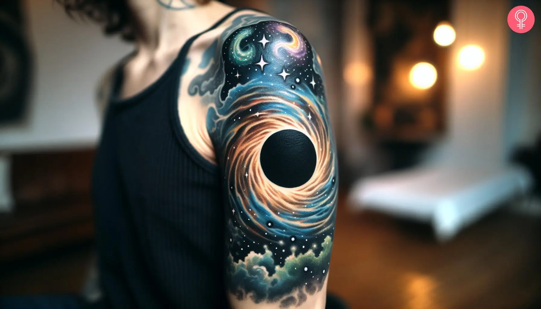 A woman with a black hole space tattoo on her upper arm