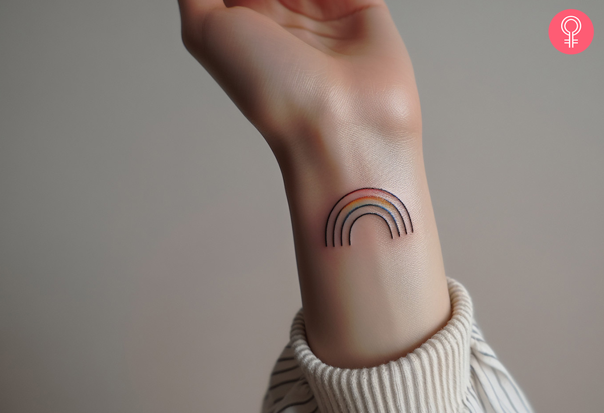 Girl with a black rainbow tattoo on the wrist