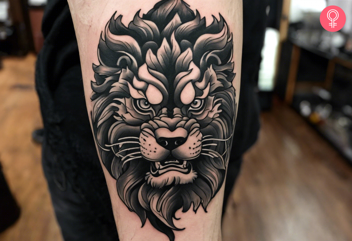 Black and gray foo dog tattoo on the upper arm