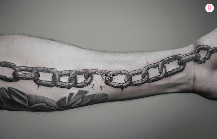 Broken chain tattoo on a man’s forearm