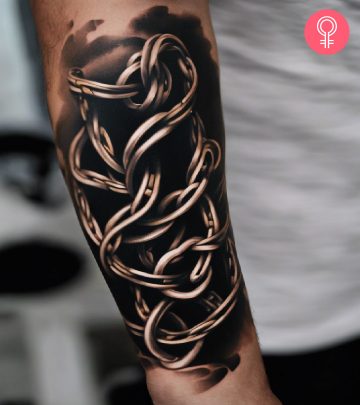 A woman with a colorful dogwood flower tattoo on her upper arm