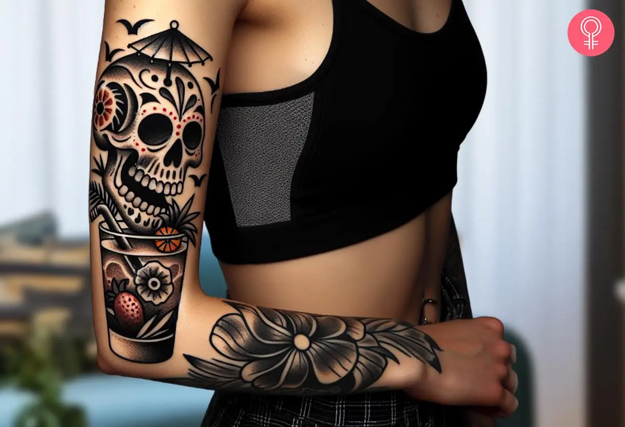 Woman with an upper arm skull and cocktail tattoo