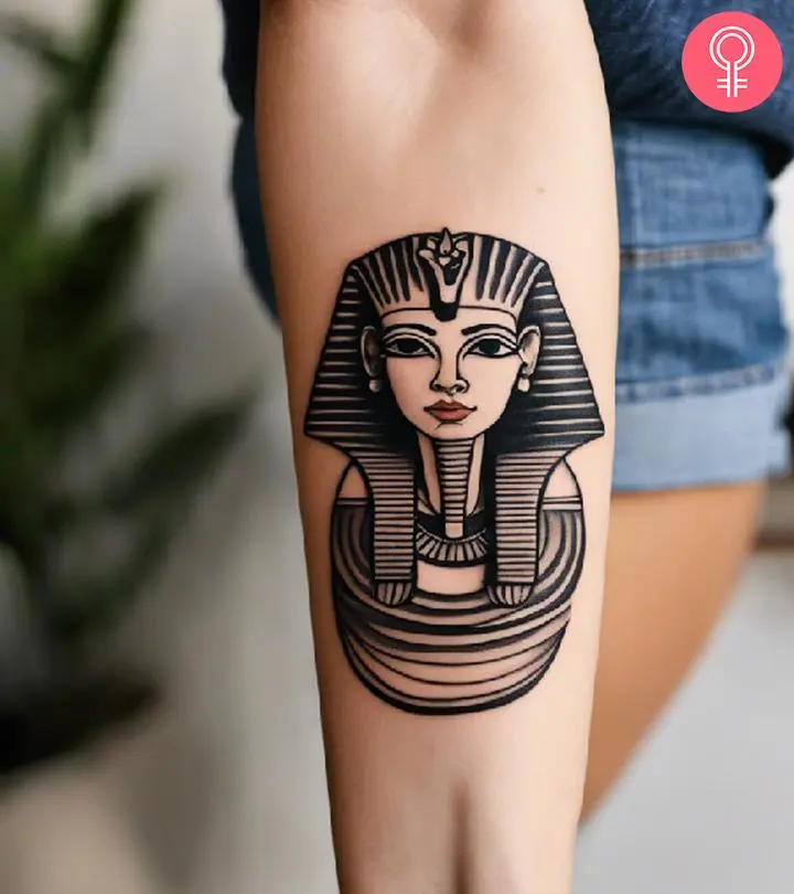 A woman with a sphinx tattoo on her forearm