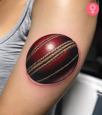 Cricket ball tattoo on the arm