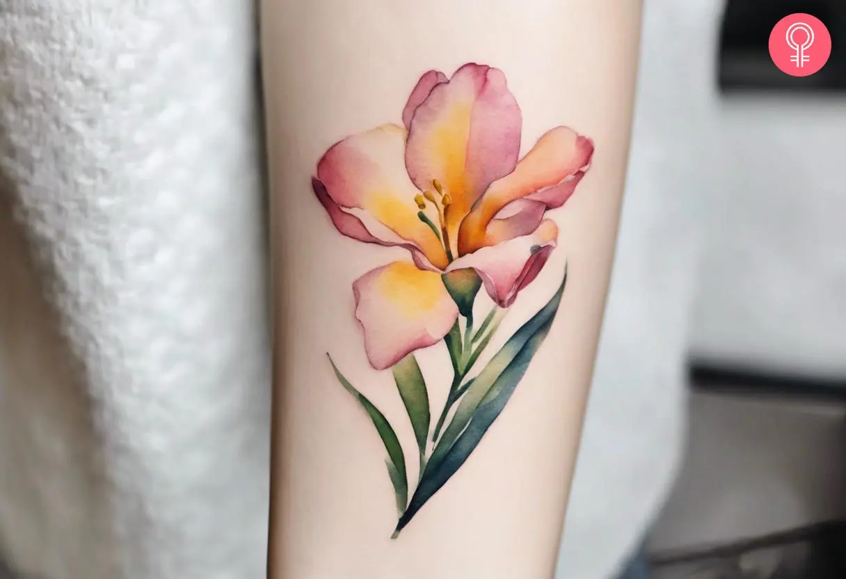 Watercolor freesia tattoo on the forearm