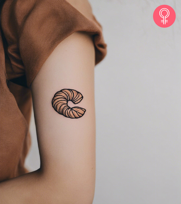 Woman with croissant tattoo on her arm