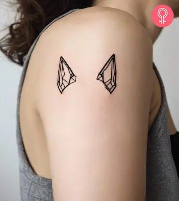 Dog ear tattoo on the arm