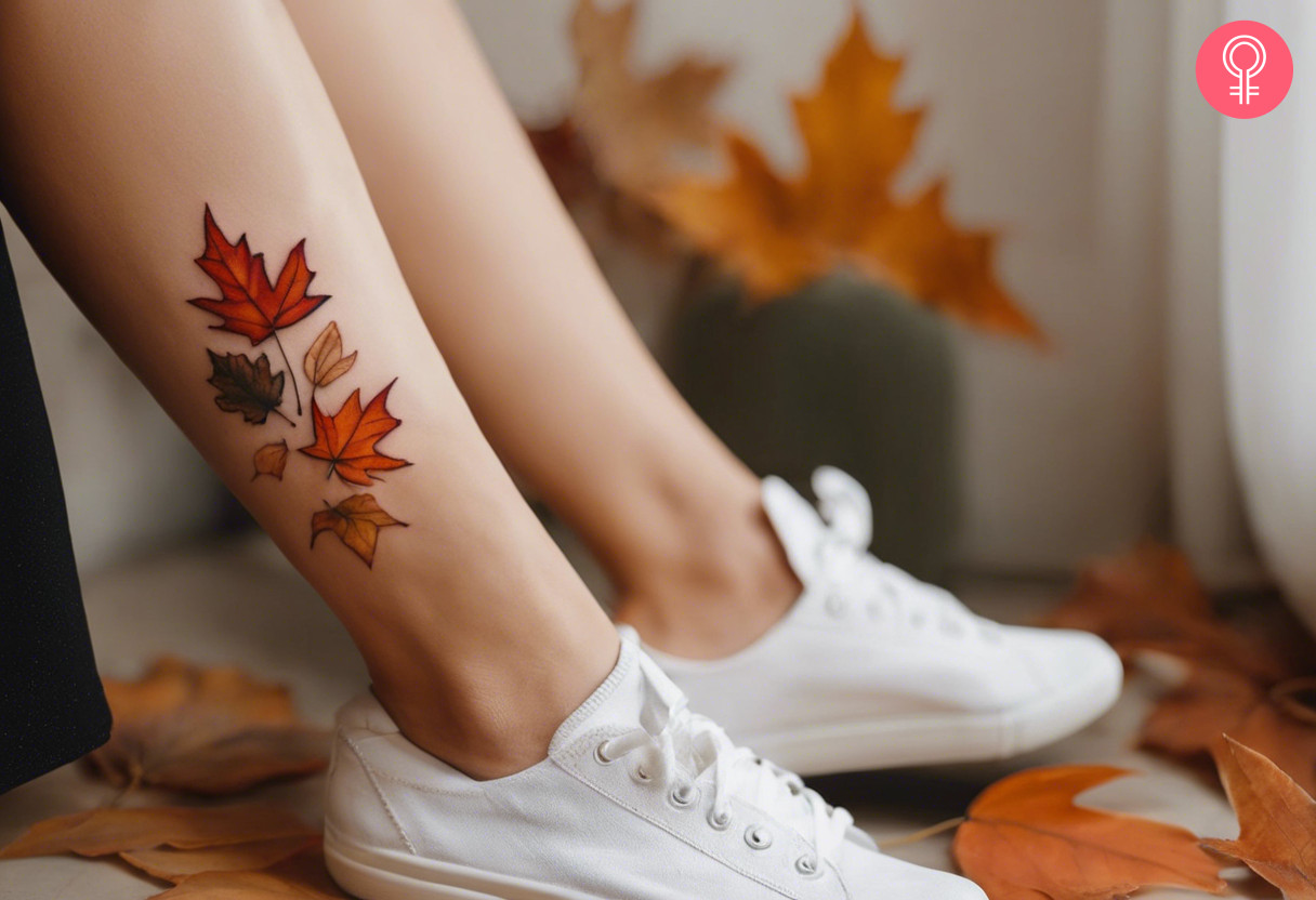 Fall foliage tattoo featuring scattered maple leaves on the ankle