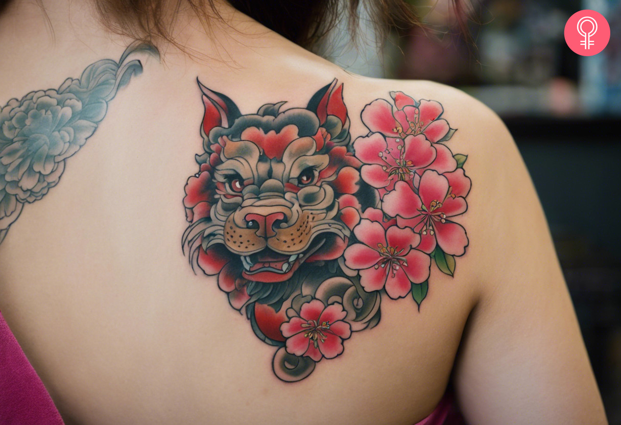 Foo dog with cherry blossom tattoo on the shoulder