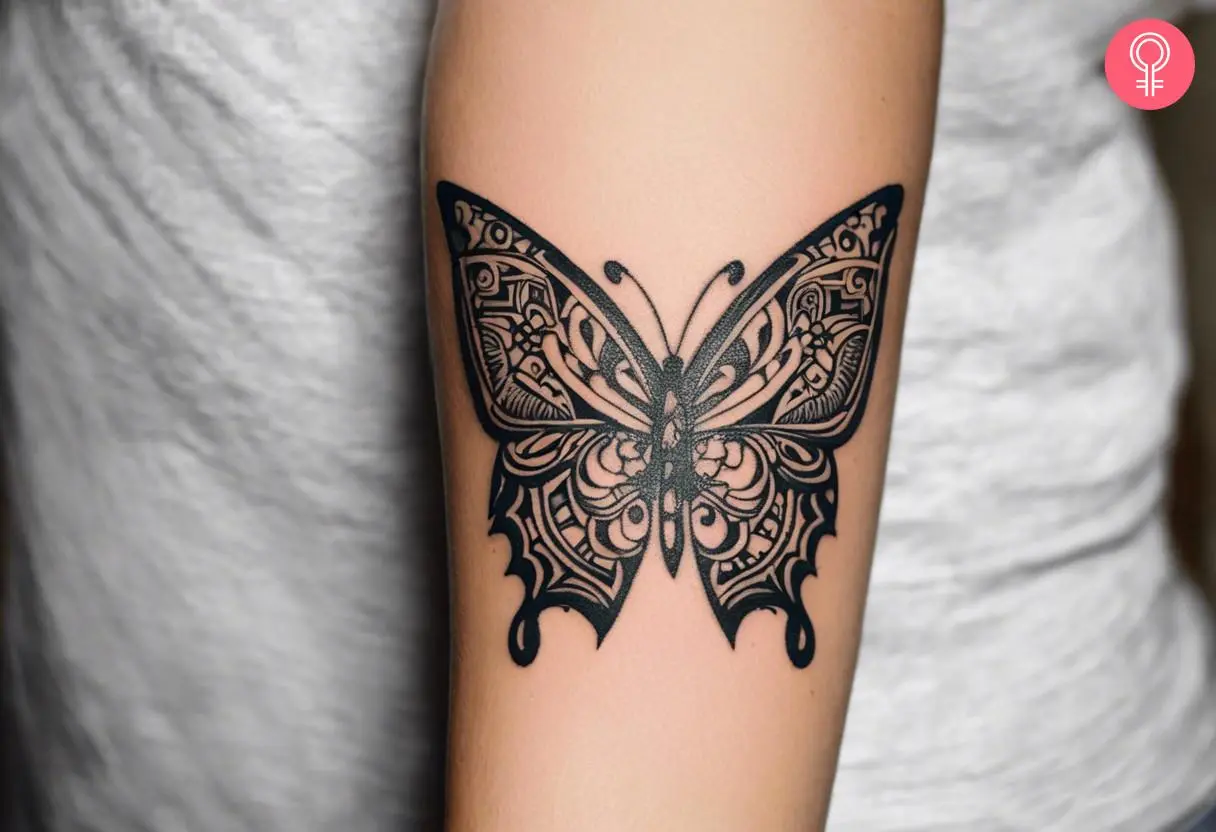 Polynesian butterfly tattoo on the forearm