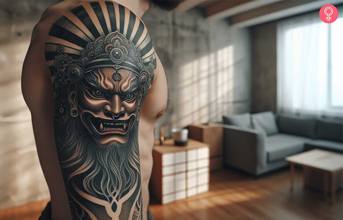 A Fudo Myoo head tattoo on a man’s upper arm