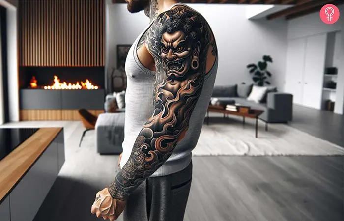 Man with a black and gray Fudo Myoo sleeve tattoo