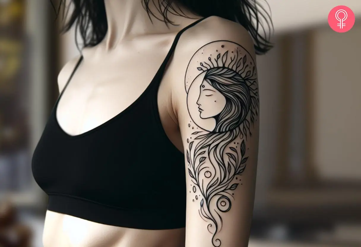 A woman with a black Gaia goddess tattoo on her upper arm