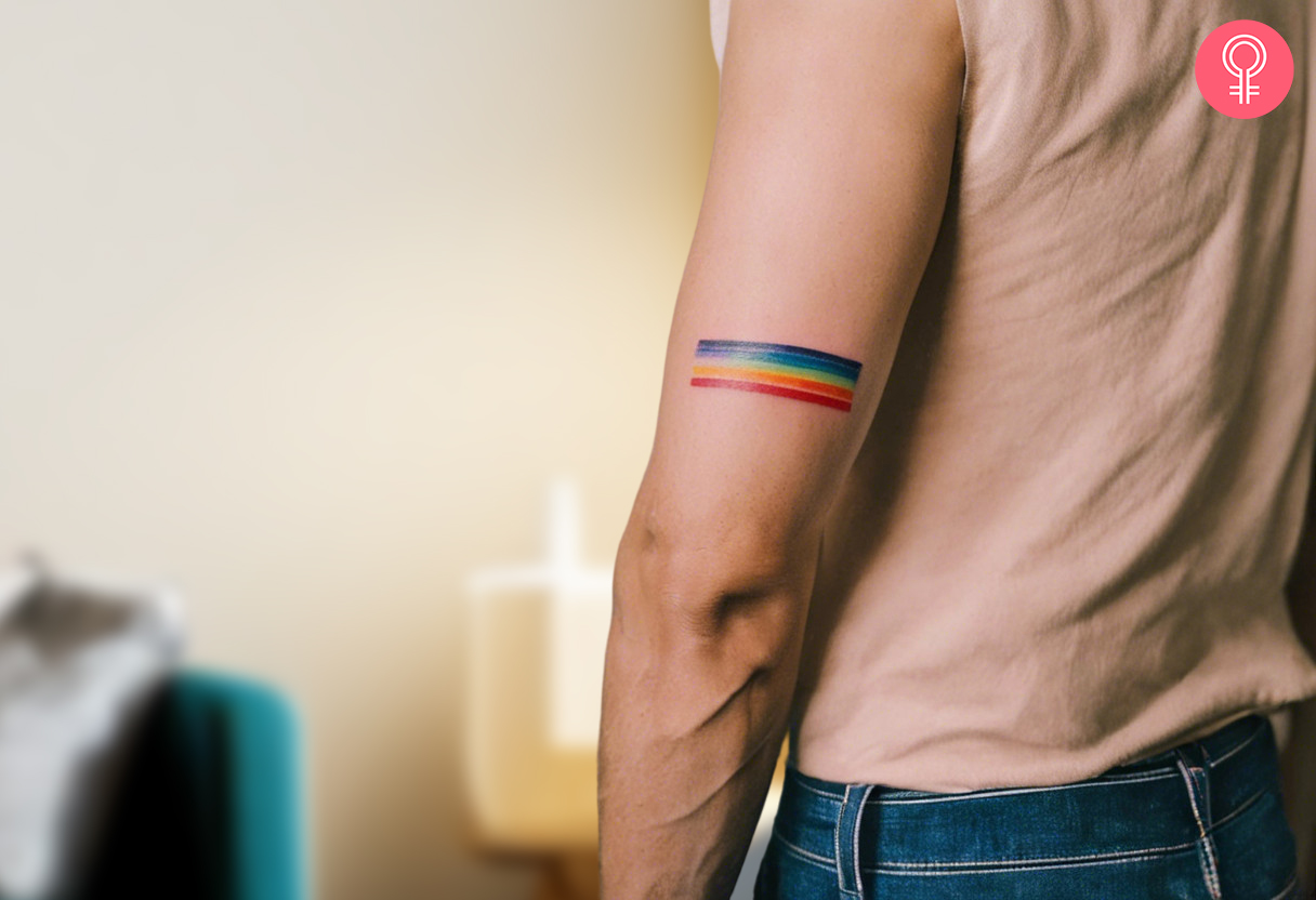 Man with a gay pride tattoo featuring a rainbow in a triangle