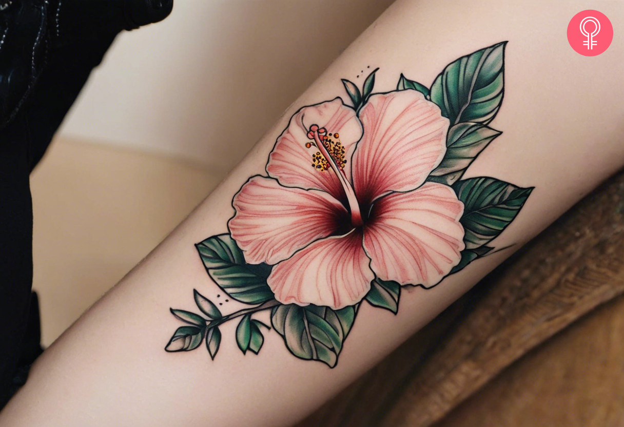 A woman with a hibiscus forearm tattoo