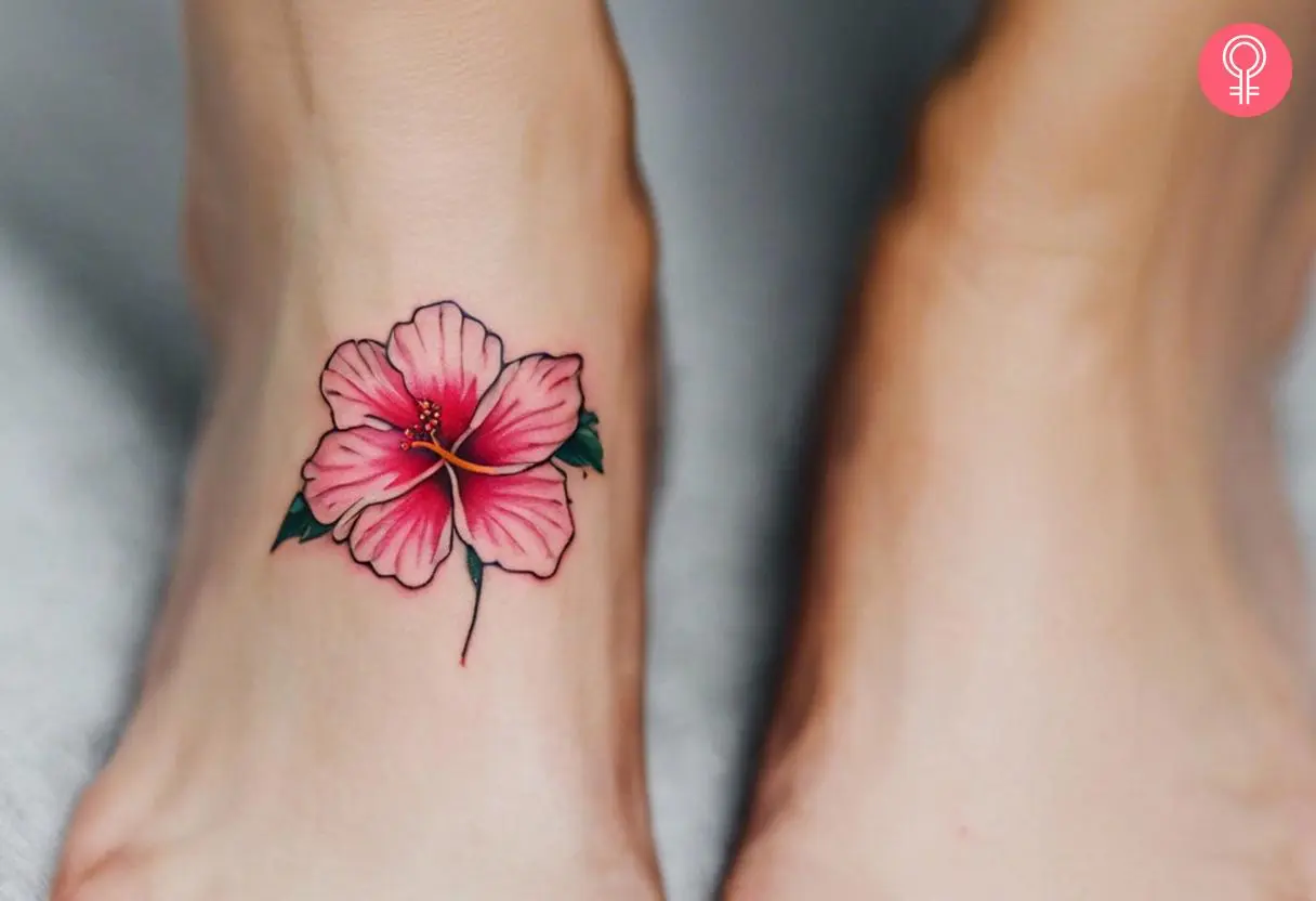 A hibiscus tattoo on the foot of a woman