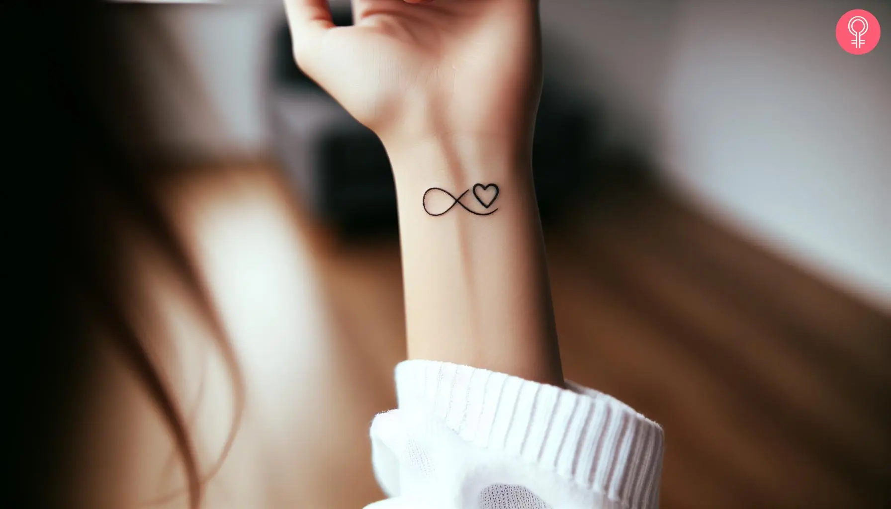 A woman with an infinity heart tattoo on her wrist