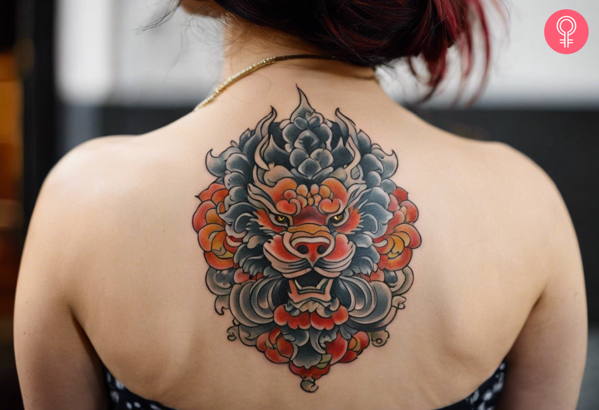 Japanese foo dog tattoo on the back of a woman