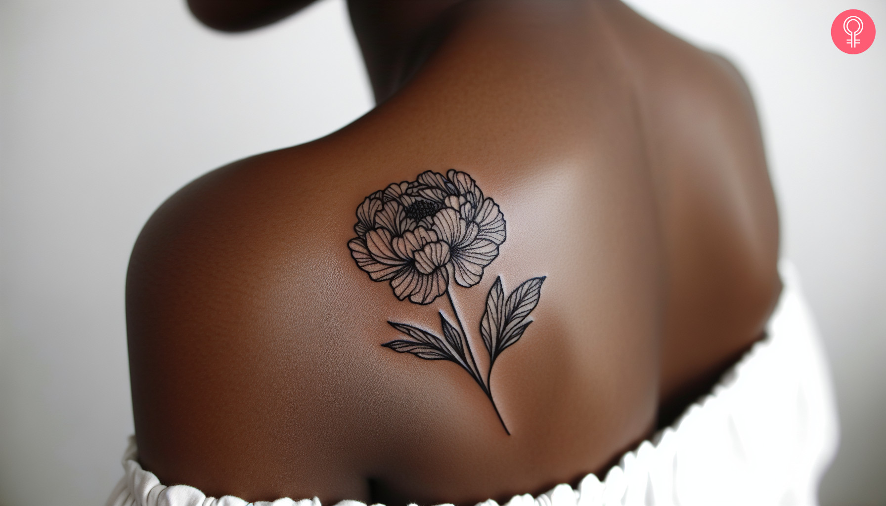 A woman with a linework peony tattoo on her shoulder