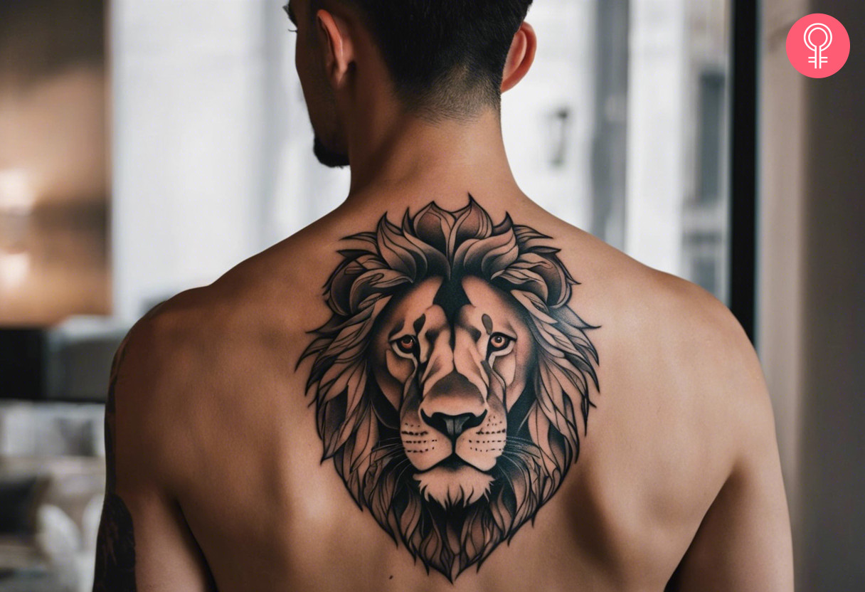 A blackwork Lion head tattoo on the middle of the back