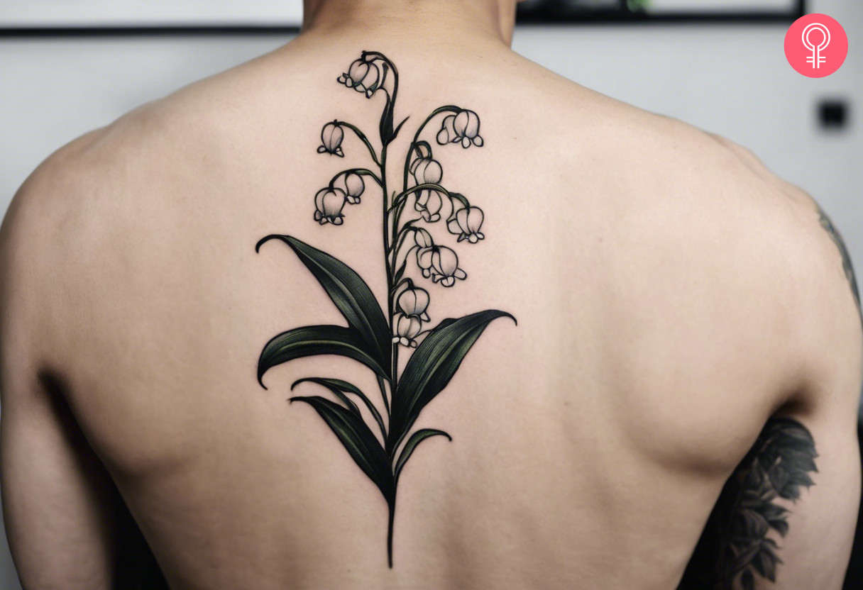 Lily of the Valley tattoo on a man’s spine