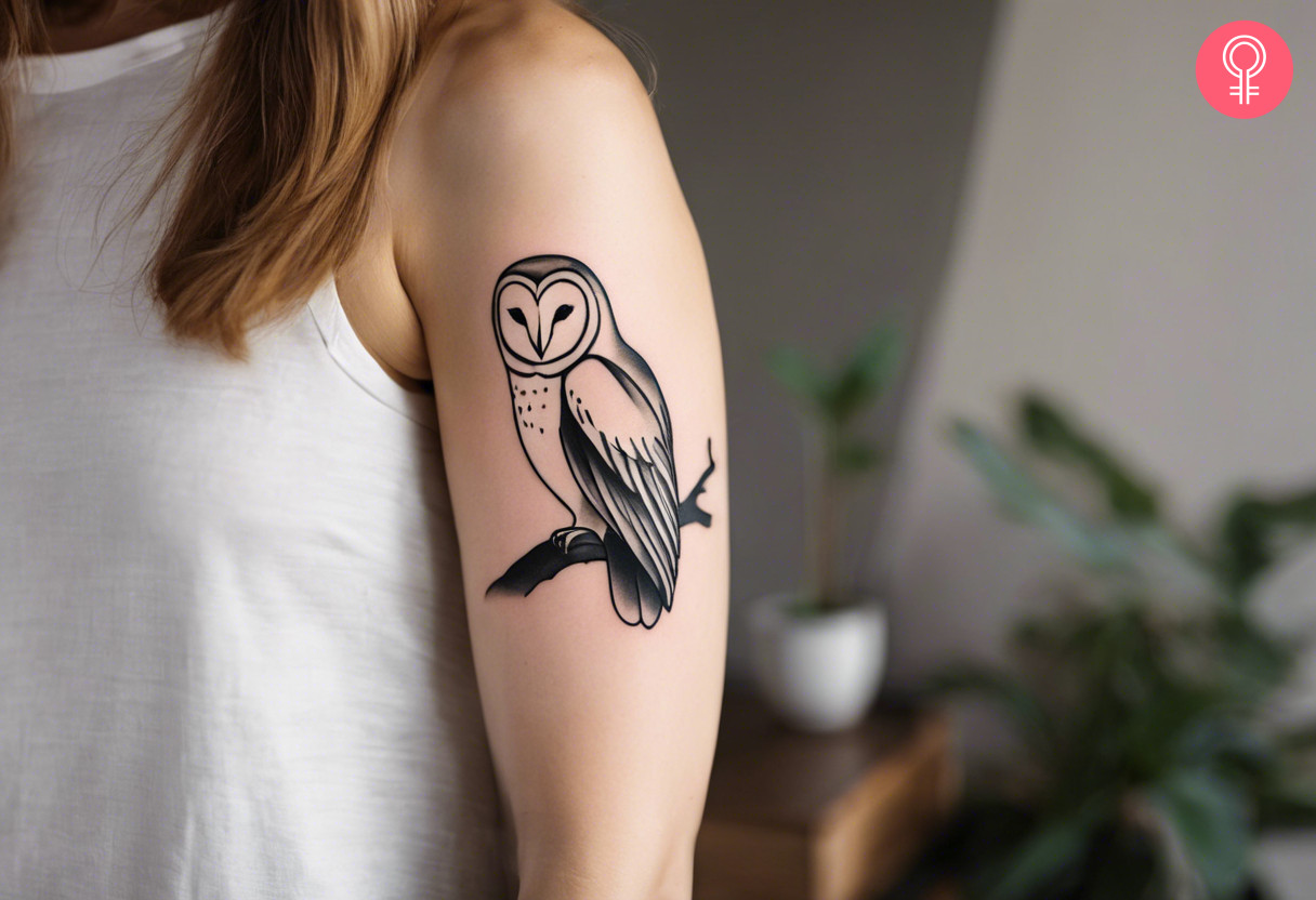 A woman with a minimalist barn owl tattoo on her upper arm