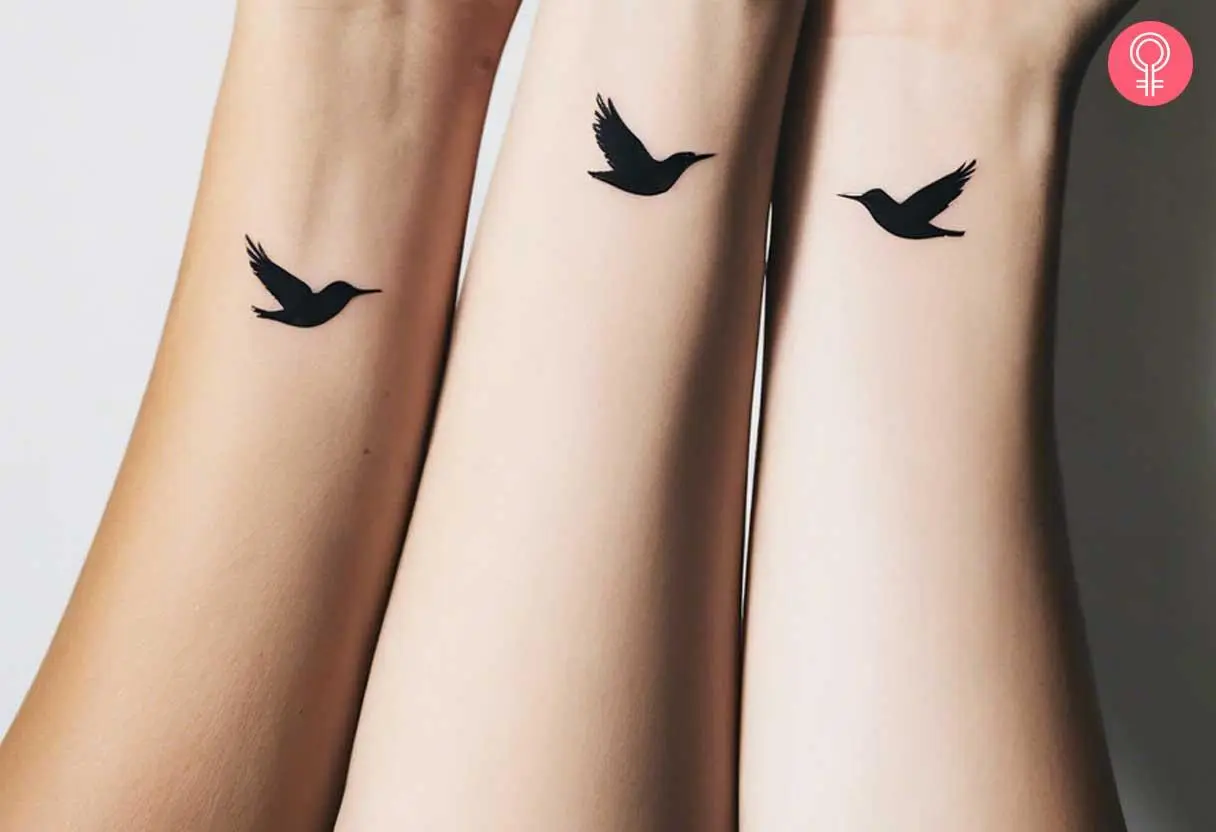 Minimalist black bird on wrist tattoo