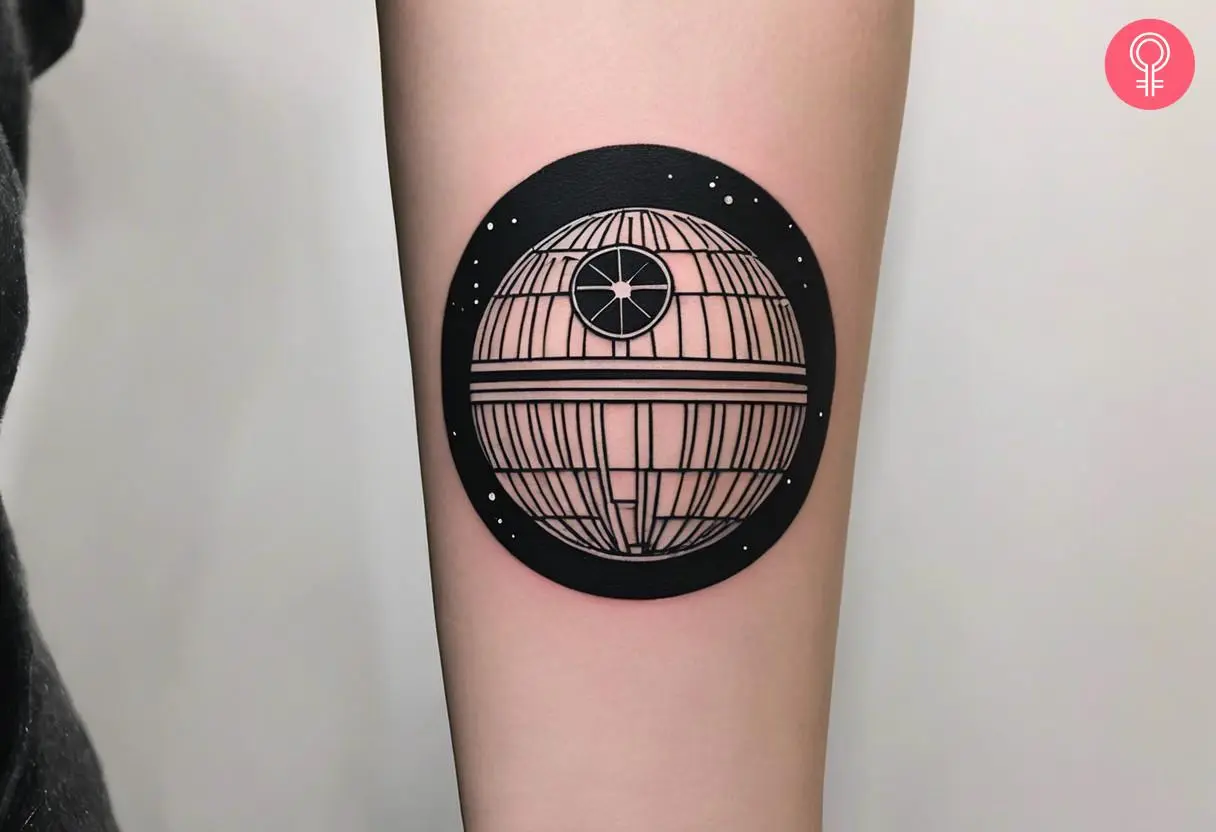 Minimalist death star tattoo on the forearm