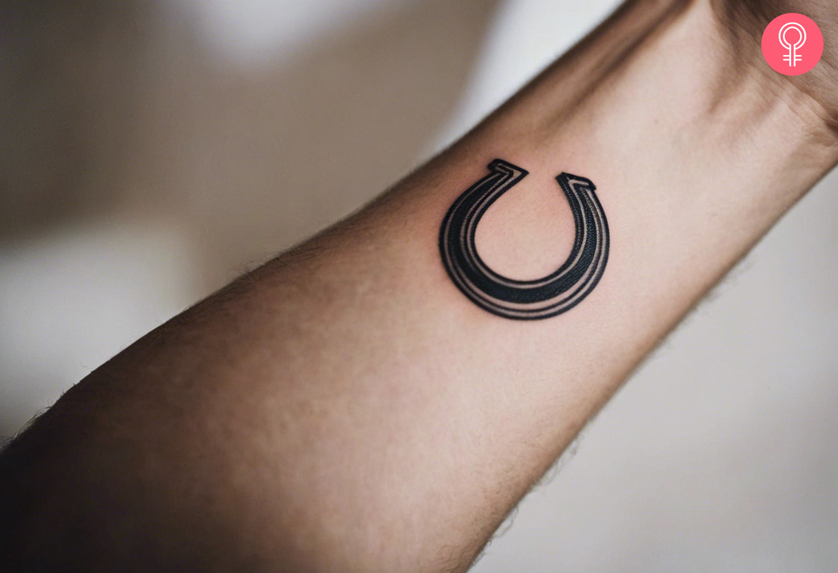 Minimalist horseshoe tattoo on the wrist