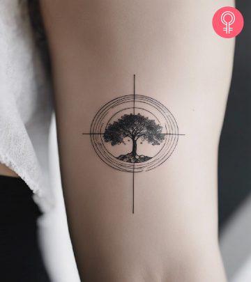 A tree and root tattoo on a woman’s arm