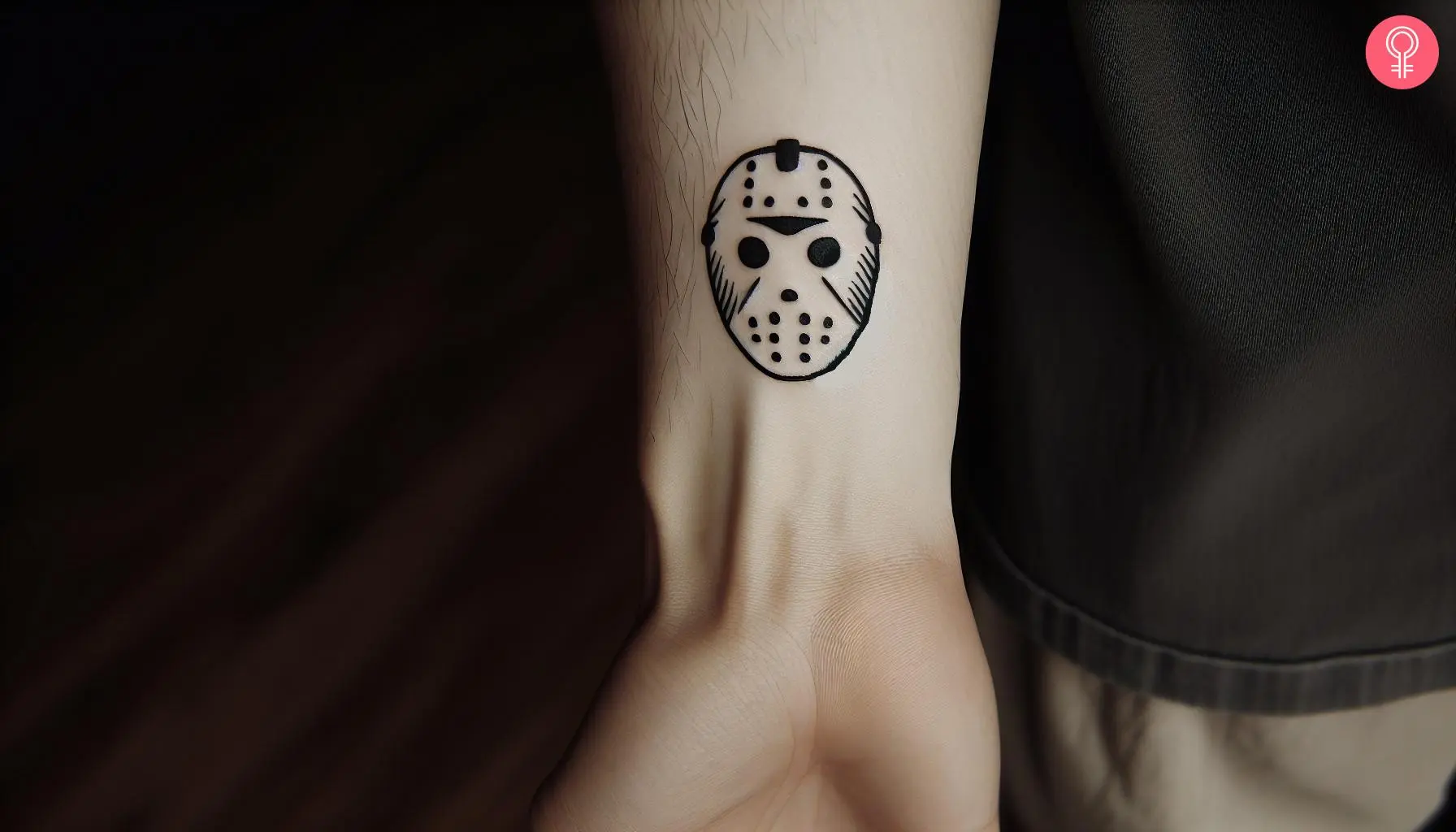 An outline Jason mask tattoo inked on the wrist