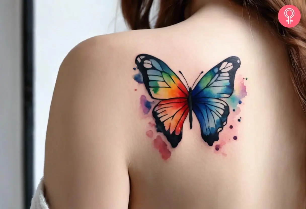 Rainbow butterfly tattoo on a woman’s arm