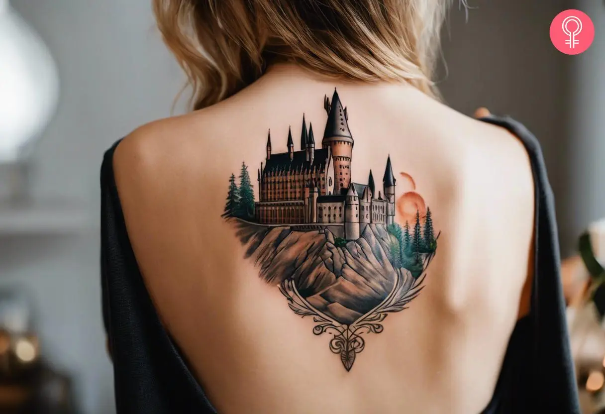 A woman with a realistic Hogwarts castle tattoo on her back