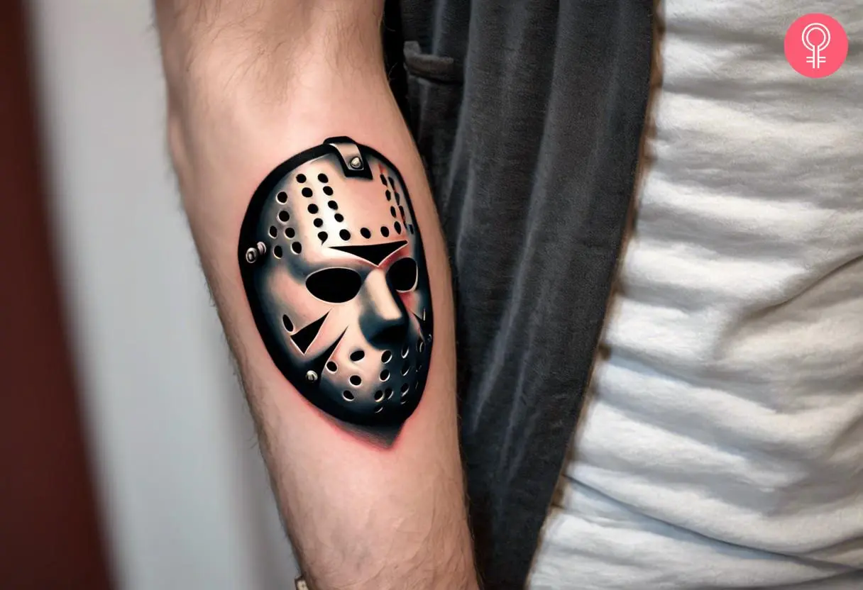 A realistic Jason mask tattoo inked on the forearm