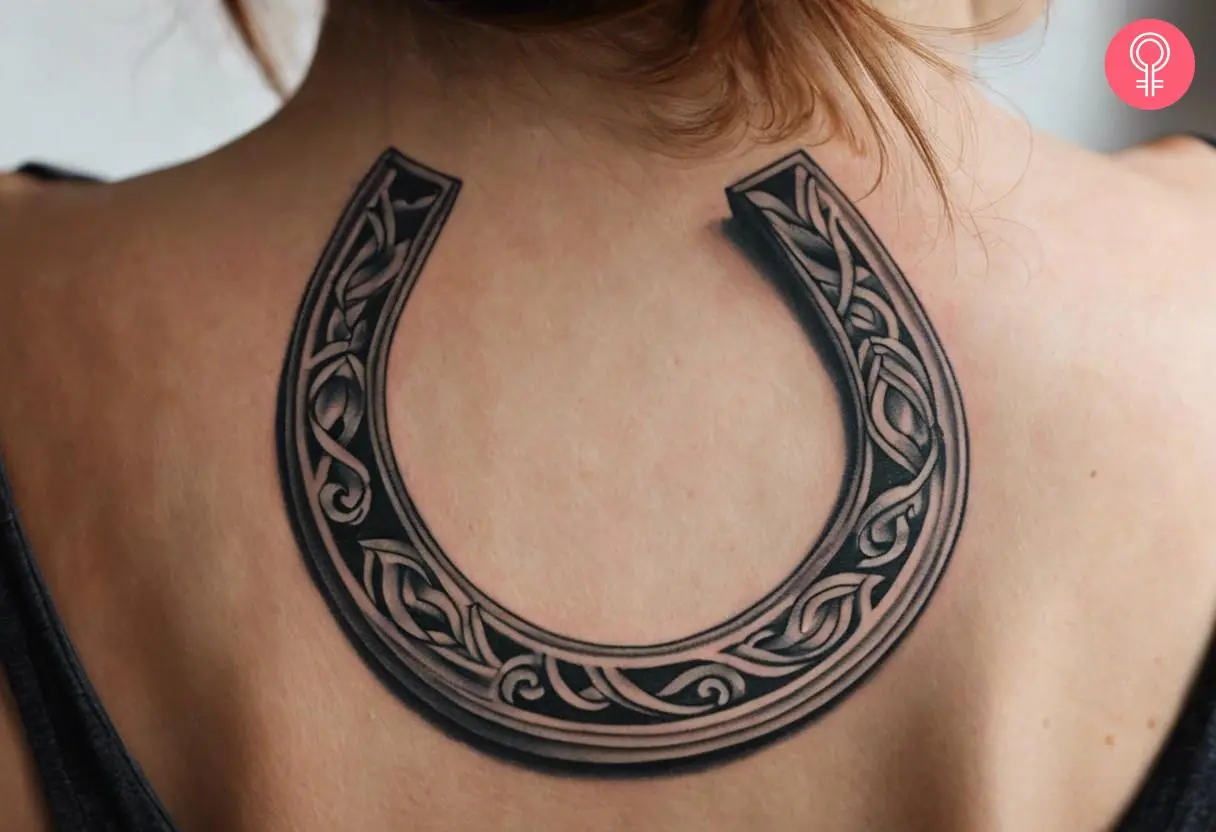 Realistic horseshoe tattoo on the back